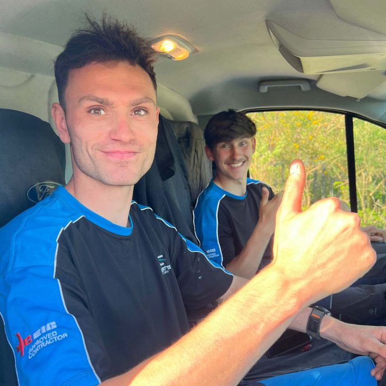 Albert and cole sat inside of Albert's Electrical van.
